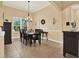 Dining room with dark wood table, chairs, chandelier and neutral walls at 15415 Mulholland Rd, Parrish, FL 34219