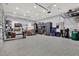 Expansive garage is equipped with work areas, storage cabinets, drumset, and ample space for tools at 15415 Mulholland Rd, Parrish, FL 34219