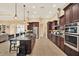 Kitchen with granite countertops, dark wood cabinets, and stainless steel appliances at 15415 Mulholland Rd, Parrish, FL 34219