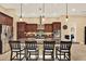 Kitchen island with granite countertops and dark wood cabinets at 15415 Mulholland Rd, Parrish, FL 34219