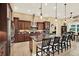Kitchen island with granite countertops, dark wood cabinets, and stainless steel appliances at 15415 Mulholland Rd, Parrish, FL 34219