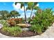 Artistic yard landscaping showcasing beautiful flowers and plants, including a rock feature at 15415 Mulholland Rd, Parrish, FL 34219