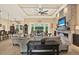 Open-concept living space with a decorative ceiling, stone fireplace, and seamless flow to the outdoors at 15415 Mulholland Rd, Parrish, FL 34219