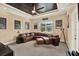 Spacious living room with leather sectional, movie poster decor, and tray ceiling at 15415 Mulholland Rd, Parrish, FL 34219