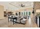 Expansive living room with a decorative ceiling, stone fireplace, and convenient access to the kitchen at 15415 Mulholland Rd, Parrish, FL 34219