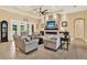 Cozy living room features a stunning stone fireplace, recessed lighting, and comfortable seating at 15415 Mulholland Rd, Parrish, FL 34219