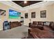 Living room features a large TV, leather sofa, movie decor, and a snack area for entertaining at 15415 Mulholland Rd, Parrish, FL 34219