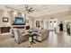 Spacious living area with a decorative ceiling, stone fireplace, and easy access to other rooms and the entryway at 15415 Mulholland Rd, Parrish, FL 34219