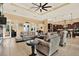 Bright living room with tile floors, ceiling fan, and neutral-colored sofas at 15415 Mulholland Rd, Parrish, FL 34219
