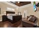 Spacious main bedroom with a wood ceiling, hardwood floors, and a seating area with a leather couch at 15415 Mulholland Rd, Parrish, FL 34219