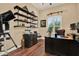Office features custom shelving, with desk and chair, and a window view, creating a productive workspace at 15415 Mulholland Rd, Parrish, FL 34219