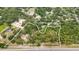 Aerial view of the property, highlighting the home's location within a lush, tree-filled landscape and outlined boundary at 16608 Livingston Ave, Lutz, FL 33559