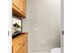Powder room featuring custom cabinetry, a flat screen tv, and toilet at 16608 Livingston Ave, Lutz, FL 33559