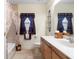 Well-lit bathroom featuring tiled floors, a shower-tub, and a modern vanity with a white countertop at 16608 Livingston Ave, Lutz, FL 33559