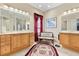Bright bathroom with double vanities, decorative bench, and large mirror at 16608 Livingston Ave, Lutz, FL 33559