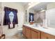 Well-maintained bathroom with a spacious vanity, toilet, and framed mirror, offering a functional design at 16608 Livingston Ave, Lutz, FL 33559