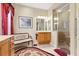 Bathroom featuring patterned rug, frameless shower, and decorative bench at 16608 Livingston Ave, Lutz, FL 33559