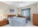 Well-lit bedroom with a comfortable bed, soft carpet, and classic decor with a pleasant, relaxing vibe at 16608 Livingston Ave, Lutz, FL 33559