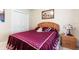 Comfortable bedroom with a patterned bedspread and soft lighting, perfect for relaxation and sleep at 16608 Livingston Ave, Lutz, FL 33559
