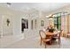 Open dining room area with elegant light fixture, large windows, and access to other rooms at 16608 Livingston Ave, Lutz, FL 33559