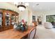 Traditional dining room with wooden table, floral arrangement, and ornate china cabinet at 16608 Livingston Ave, Lutz, FL 33559