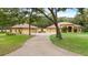 Sprawling estate featuring a long driveway leading to a well-maintained home with lush landscaping at 16608 Livingston Ave, Lutz, FL 33559