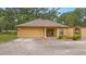 Charming single-story home with a paved driveway, attached garage, and well-manicured landscaping at 16608 Livingston Ave, Lutz, FL 33559