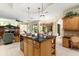 Open kitchen with a kitchen island, pendant lighting, and seamless access to the living area at 16608 Livingston Ave, Lutz, FL 33559