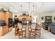 Bright kitchen features wood cabinets, black appliances, bar seating, and stylish pendant lighting at 16608 Livingston Ave, Lutz, FL 33559