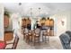 Well-lit kitchen with a kitchen island, stainless steel appliances, and a view of living areas at 16608 Livingston Ave, Lutz, FL 33559