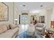 Inviting living room with tiled floors, neutral decor, and large windows for natural light at 16608 Livingston Ave, Lutz, FL 33559