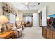 Inviting sitting room boasts carpet, soft lighting, floral drapes, and an entertainment center at 16608 Livingston Ave, Lutz, FL 33559