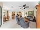 Spacious living room with tile flooring, ceiling fan, and comfortable seating adjacent to kitchen and dining area at 16608 Livingston Ave, Lutz, FL 33559
