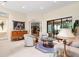 Spacious living room featuring tile flooring, neutral tones, and sliding glass doors to the outdoor patio at 16608 Livingston Ave, Lutz, FL 33559