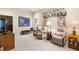 Cozy sitting room featuring carpeted floors, a large window, comfortable seating, and soft, natural lighting at 16608 Livingston Ave, Lutz, FL 33559
