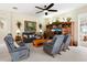 Comfortable seating arrangement in a living room with a ceiling fan and decor at 16608 Livingston Ave, Lutz, FL 33559