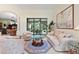 Comfortable seating arrangement in living room with tiled floors and sliding glass doors to outdoor patio at 16608 Livingston Ave, Lutz, FL 33559