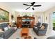 Bright living room boasts a ceiling fan, comfortable seating, and entertainment center at 16608 Livingston Ave, Lutz, FL 33559