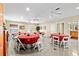 Spacious multi-purpose meeting room featuring tables, chairs, ceiling fans, and neutral-toned walls at 16608 Livingston Ave, Lutz, FL 33559
