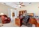 Cozy home office with a large wooden desk, comfortable chair, and a view to the hallway at 16608 Livingston Ave, Lutz, FL 33559
