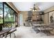 Charming outdoor kitchen with granite countertops, a grill, a ceiling fan, and a dining area at 16608 Livingston Ave, Lutz, FL 33559