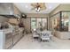 Outdoor kitchen with stainless steel grill, custom cabinetry, a ceiling fan, and a dining area at 16608 Livingston Ave, Lutz, FL 33559