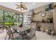 Charming outdoor kitchen with granite countertops, a grill, a ceiling fan, and a dining area at 16608 Livingston Ave, Lutz, FL 33559