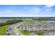 Expansive aerial view showcasing a well-planned community with lush green spaces, ponds, and organized residential blocks at 17005 Avon Dive Ln, Wimauma, FL 33598