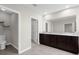 Spacious bathroom with a double vanity, granite countertop, and a separate toilet room, enhancing privacy and convenience at 17005 Avon Dive Ln, Wimauma, FL 33598