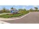 Southshore Bay community sign surrounded by lush greenery and colorful flowers at 17005 Avon Dive Ln, Wimauma, FL 33598