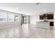 Bright living room featuring tile floors, granite counters, and access to the outdoor patio via sliding glass doors at 17005 Avon Dive Ln, Wimauma, FL 33598