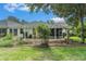 Spacious backyard featuring a well-maintained lawn, brick-laid patio, and lush landscaping at 17910 Timber View St, Tampa, FL 33647