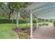 Backyard patio with a white pergola, brick flooring, and a manicured lawn at 17910 Timber View St, Tampa, FL 33647