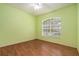 Bright bedroom with wood flooring, a ceiling fan, and a large window at 17910 Timber View St, Tampa, FL 33647